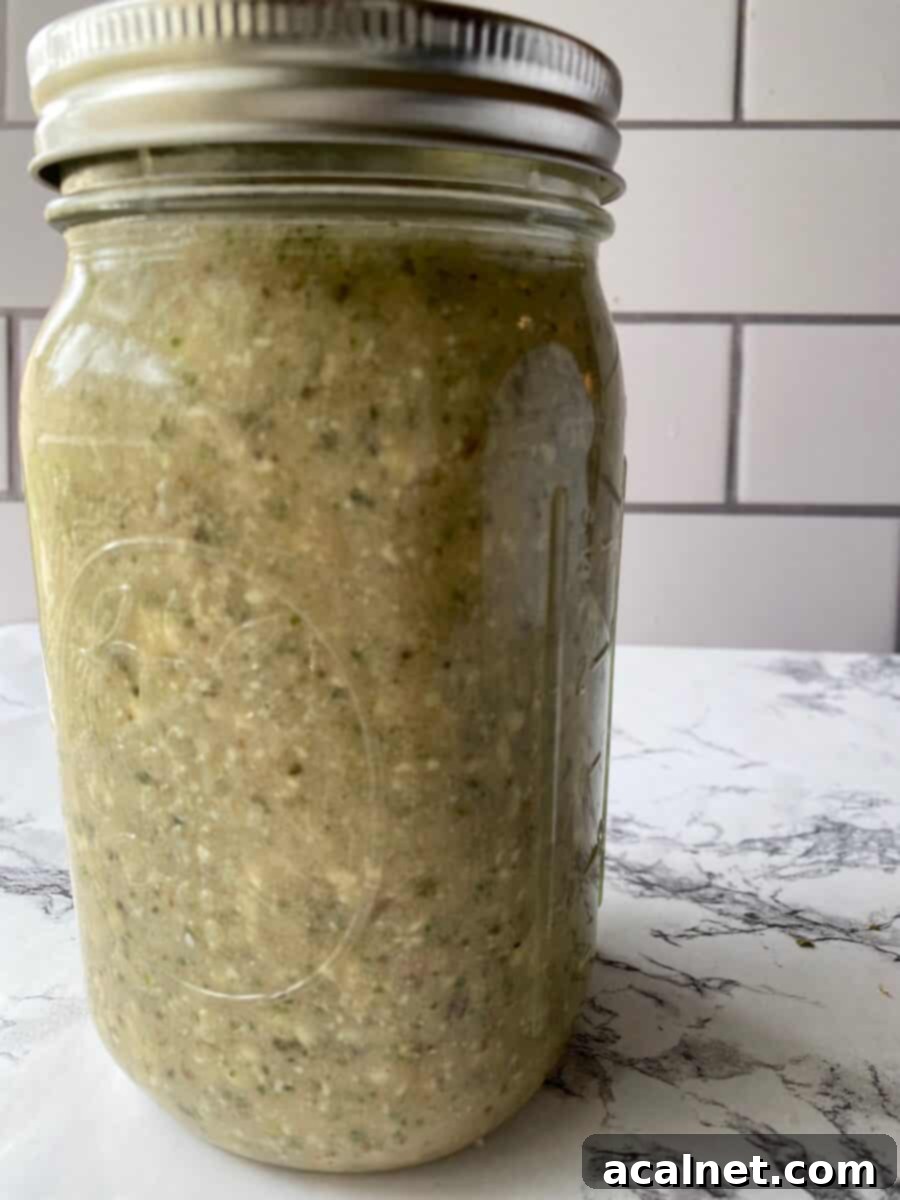 A glass jar full of salad dressing.