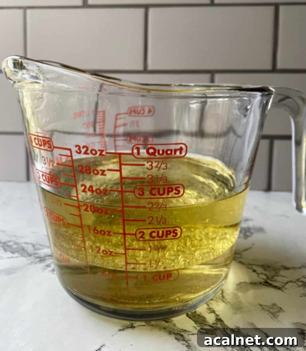 Olive oil and white wine vinegar in a 4-cup glass measuring cup.