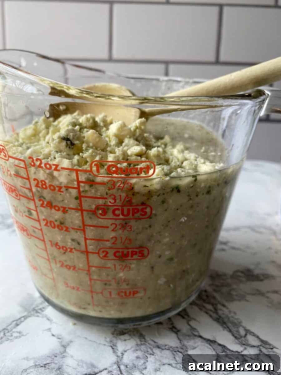 Blue cheese crumbles on top of blended ingredients.