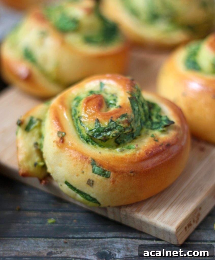 Close up view of a golden-brown Spinach and Ricotta Roll, showcasing its fluffy texture