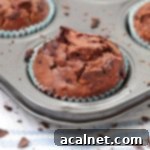 One Chocolate and Zucchini Muffin in the muffin pan