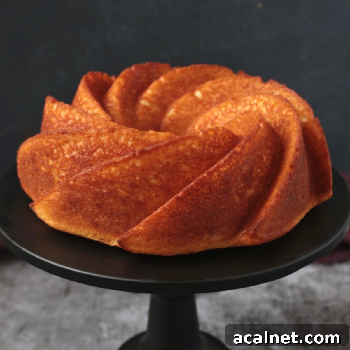 Lemon Yogurt Cake on a cake stand