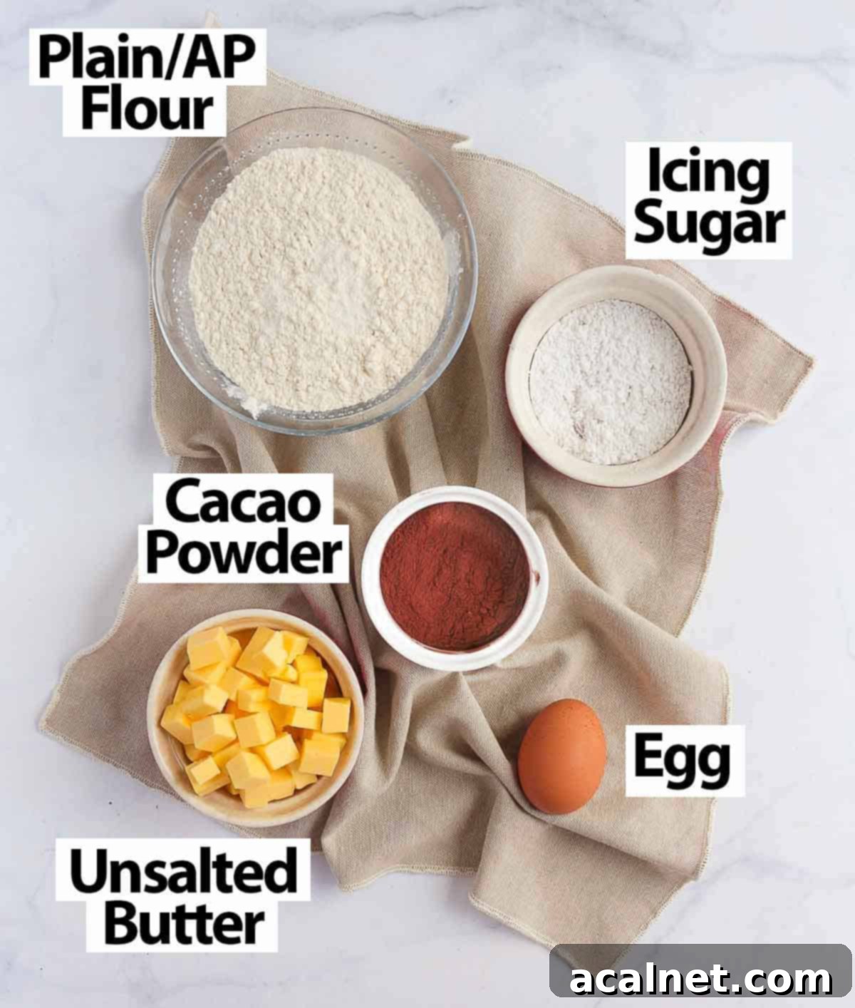 Decadent French Chocolate Tart 4 Chocolate Pastry Ingredients laid over a beige napkin.