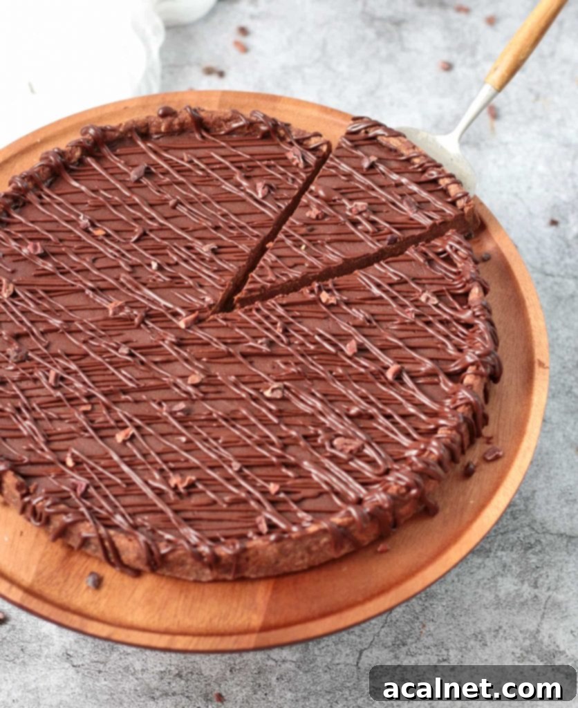 Decadent French Chocolate Tart 7 One slice cut off over a serving spoon