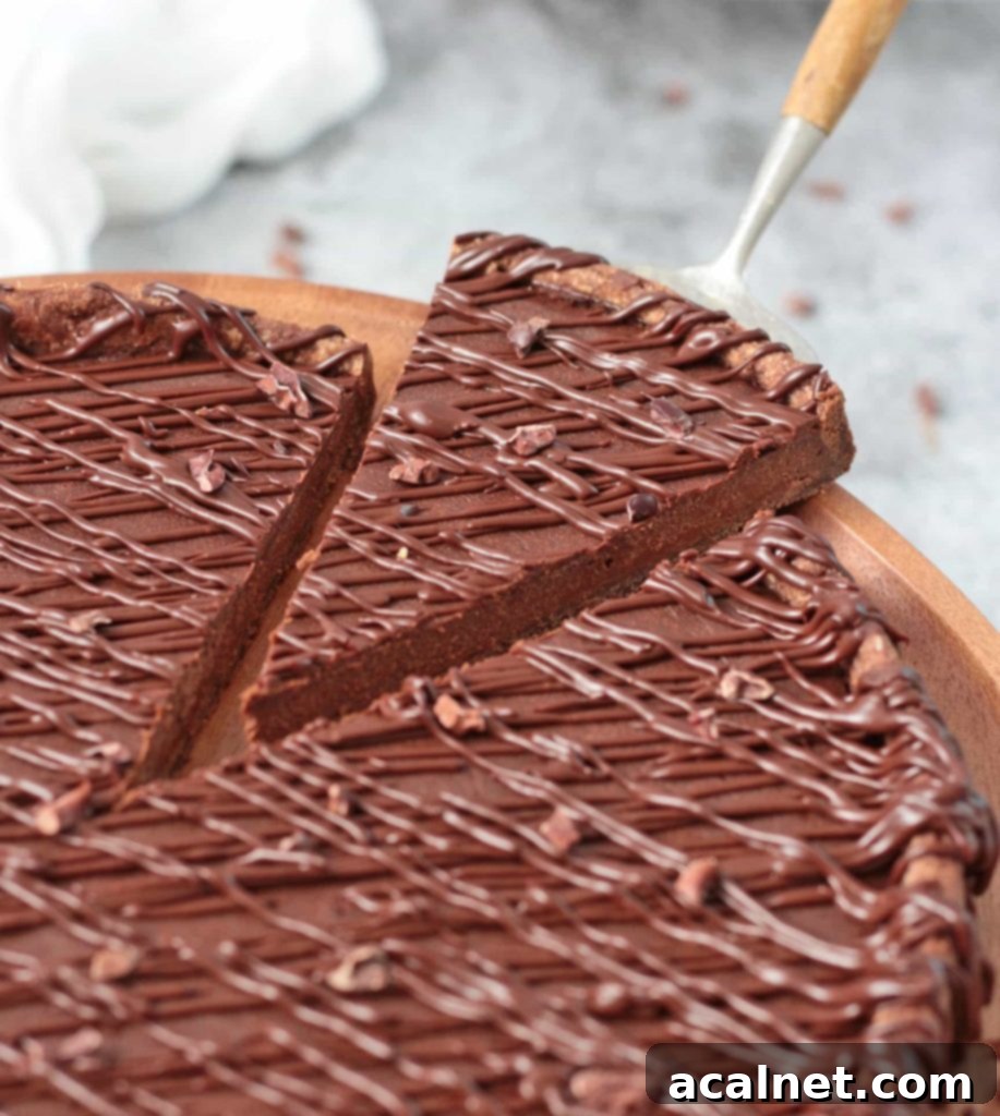Decadent French Chocolate Tart 9 Close up on a slice of tart cut off from the rest of the dessert.