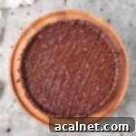 Decadent French Chocolate Tart 10 Finished tart from above on a wooden cake stand
