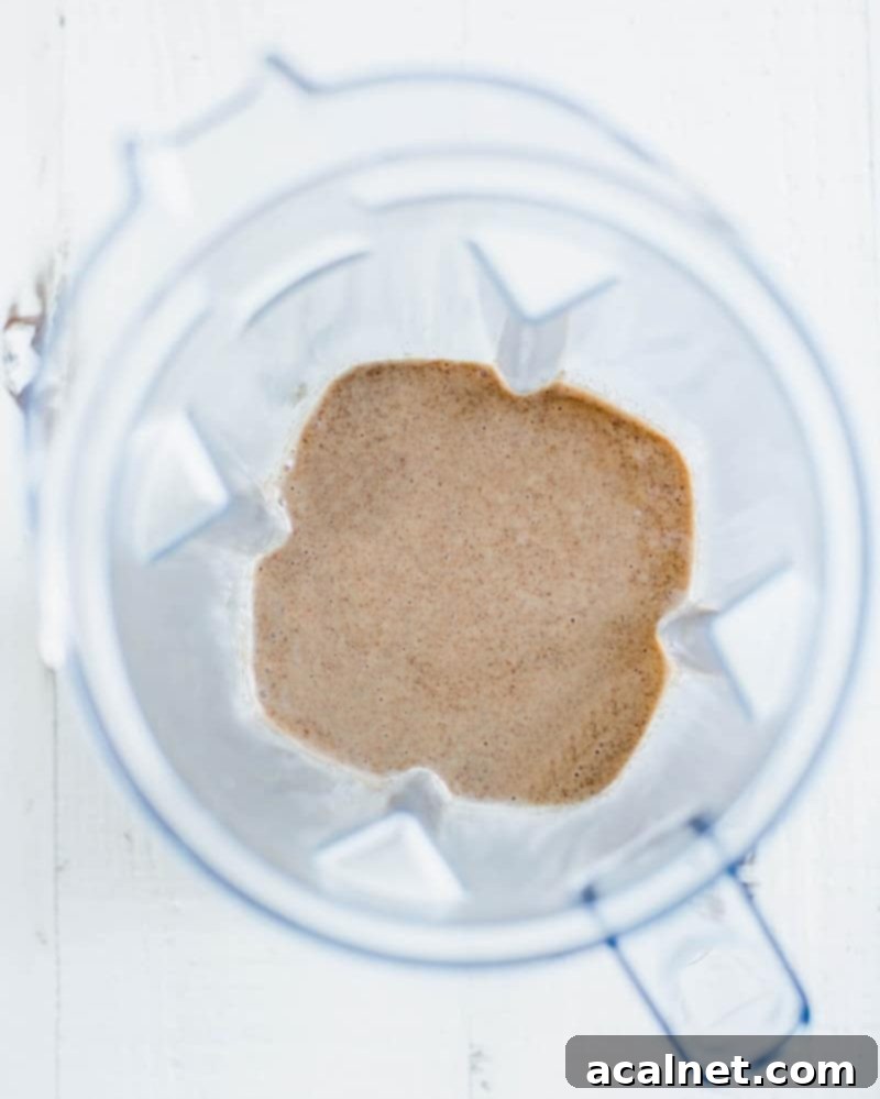 Ultimate Sweet Pancake Topping Guide 22 Almond butter fruit dip served in a small bowl, with fresh fruit for dipping in the background.