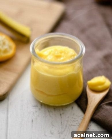 Ultimate Sweet Pancake Topping Guide 27 Low carb lemon curd in a glass jar, showing its bright yellow color.