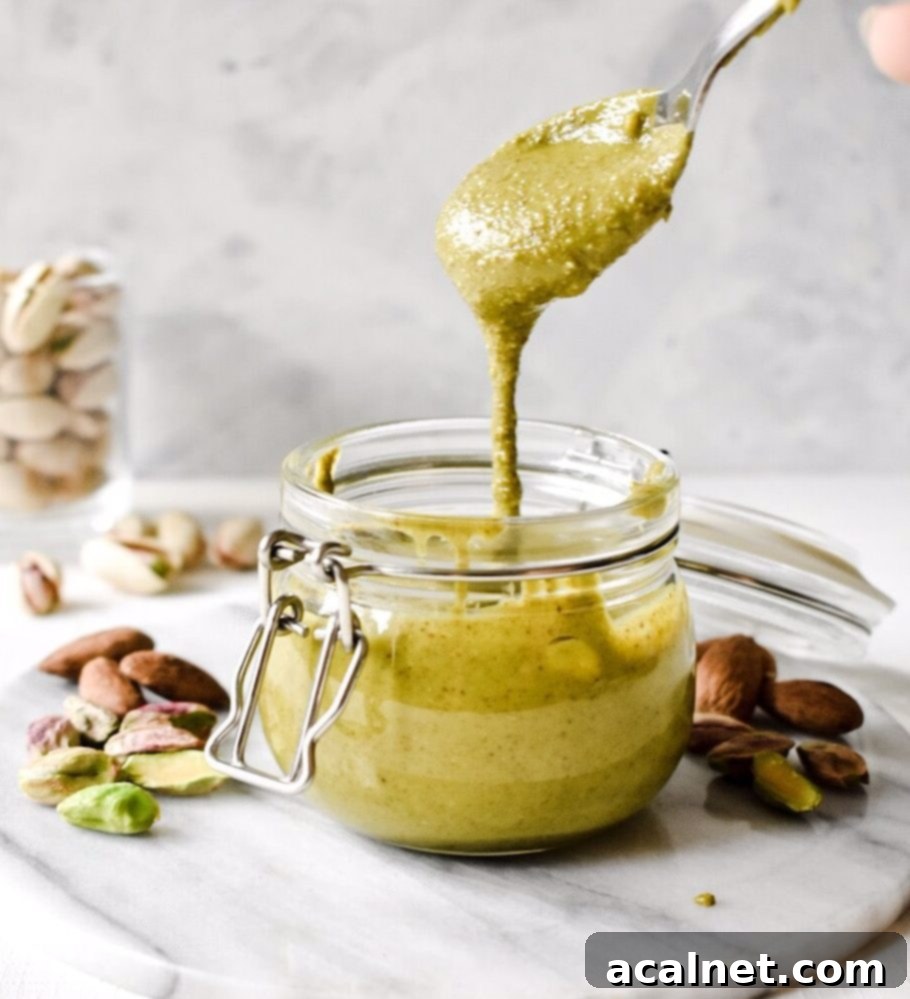 Ultimate Sweet Pancake Topping Guide 32 Creamy pistachio almond butter in a glass jar, showing its natural color.