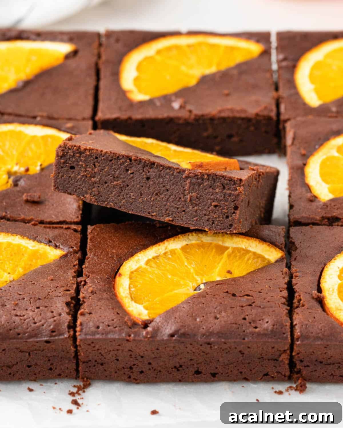 One slice stacked over the rest of the cut brownies.