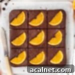 Brownies sliced in 9 on a marble cutting board seen from above.