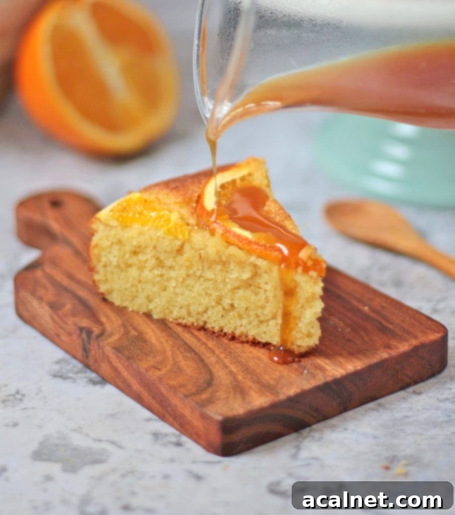 Orange syrup poured over a slice of semolina cake