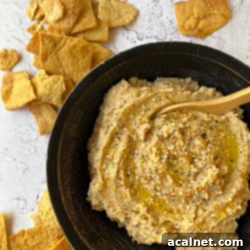 Everything-Spiced Cauliflower Hummus 12 Cauliflower Hummus in a bowl with chips scattered on the table
