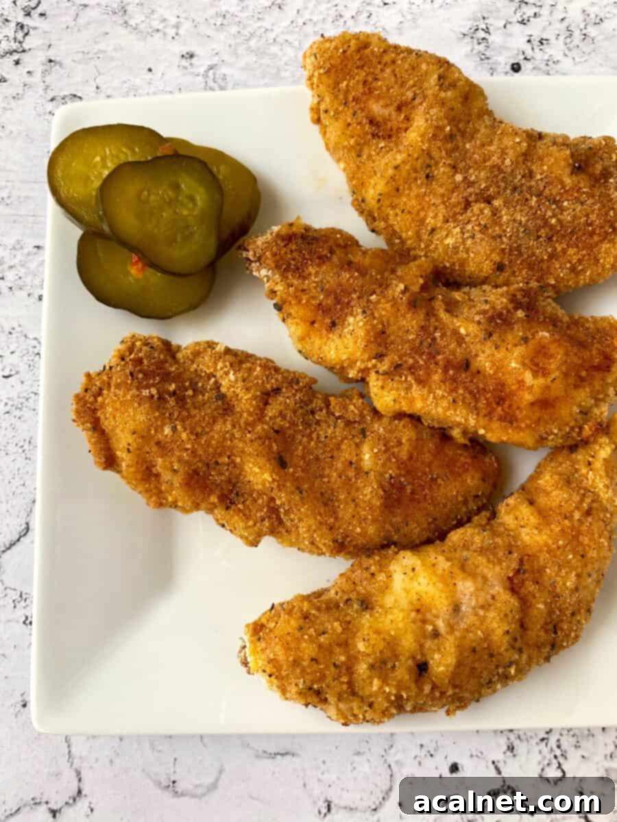 Golden Buttermilk Chicken Tenders 14 Four chicken strips on a serving plate