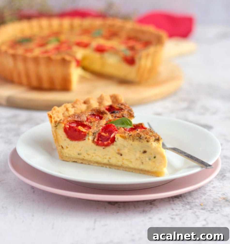 One slice of quiche on a white and pink plate