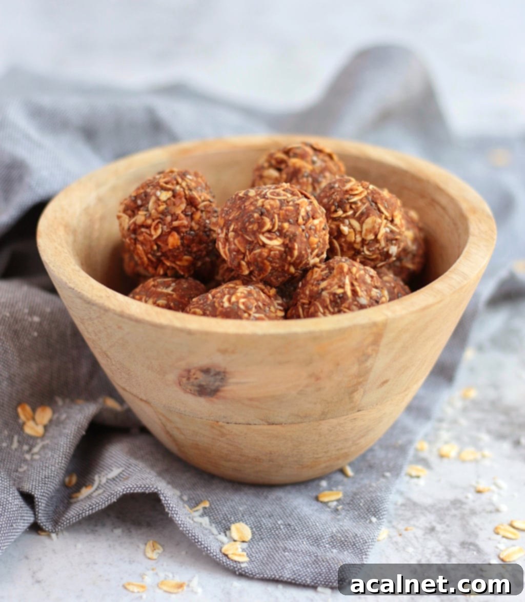Peanut Butter Chocolate Balls in a wooden bowl over a grey napkin.