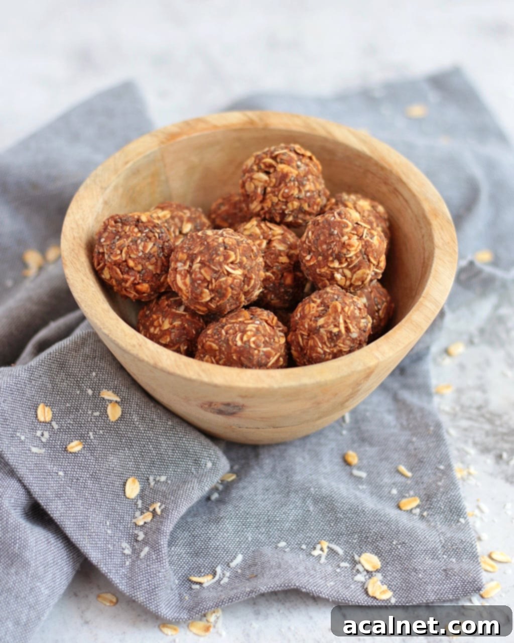 Chocolate Peanut Butter Bliss Balls in a bowl on a grey napkin