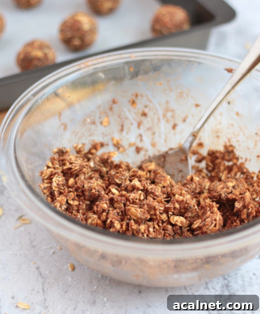 Unrolled energy ball batter in a glass mixing bowl