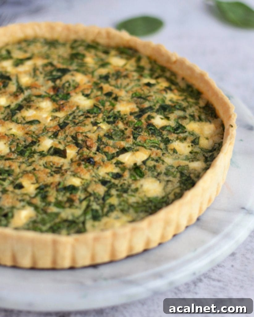 A close-up shot of the flakey, golden-brown crust of a Spinach and Feta Quiche.