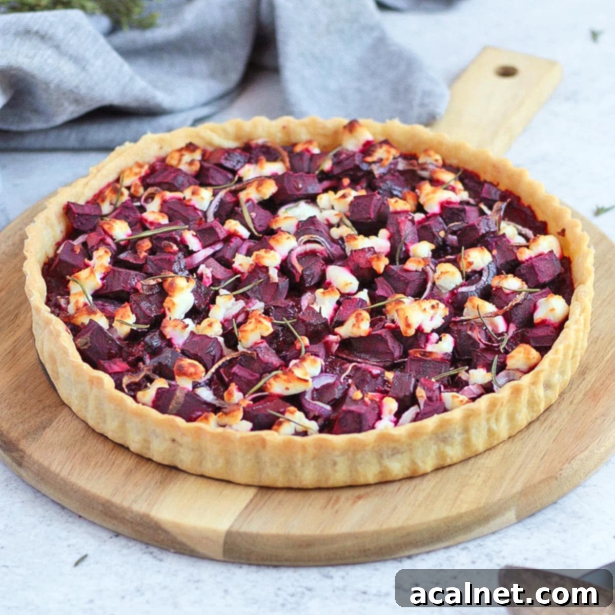 Savory Tart on a round wooden board showcasing its vibrant colors and delicious texture.
