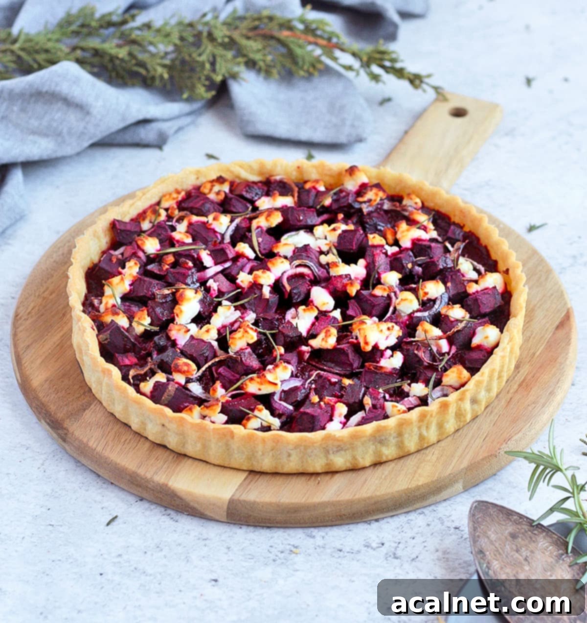Baked Savoury Tart on a wooden serving board, showcasing its golden crust and vibrant filling.
