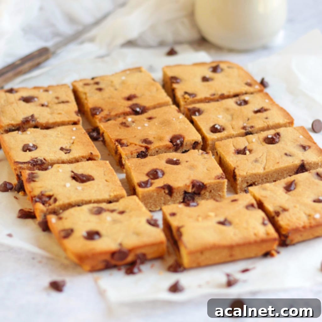 Sliced Chocolate Chip Blondie Bars on baking paper.