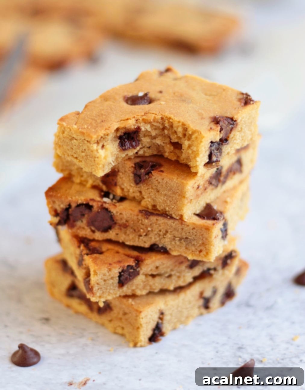 Stack of the chocolate chip bars with a bite off