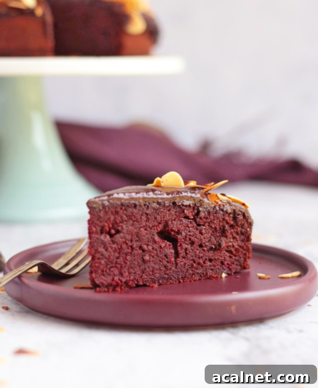 A slice of chocolate and beetroot cake on a purple plate