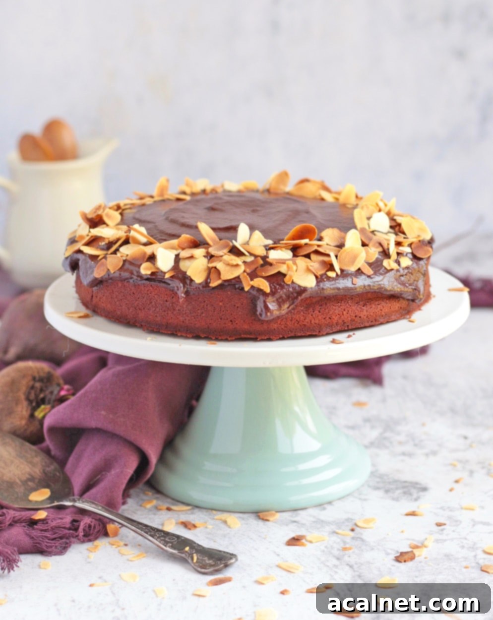 Chocolate Cake on a Cake Stand with chocolate ganache and toasted almond flakes
