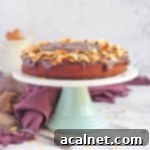 Chocolate Beetroot Cake topped with flaked almonds on a cake stand