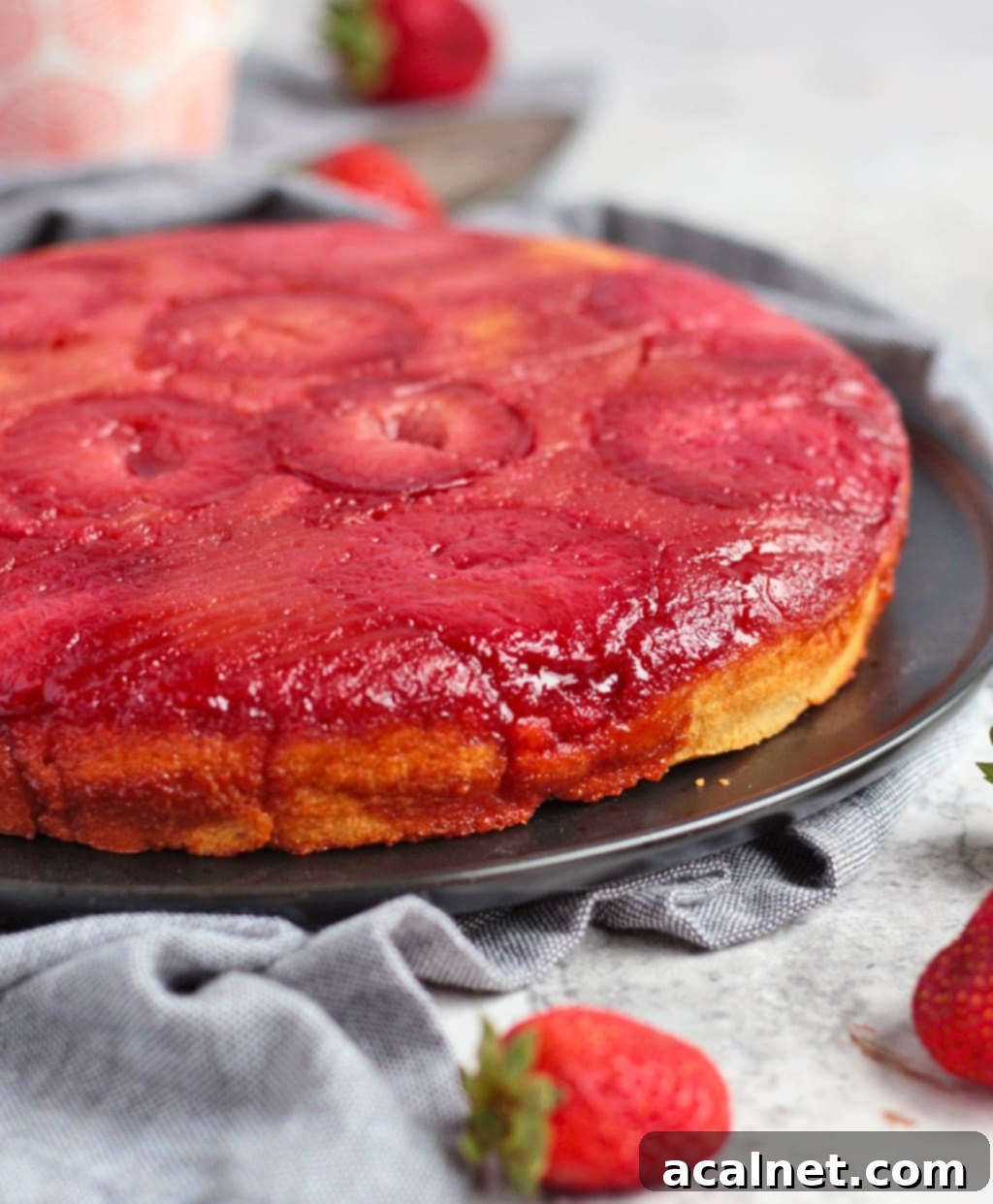Close up shot of the caramelised edges of the Plum Upside Down Cake, highlighting the juicy plums.