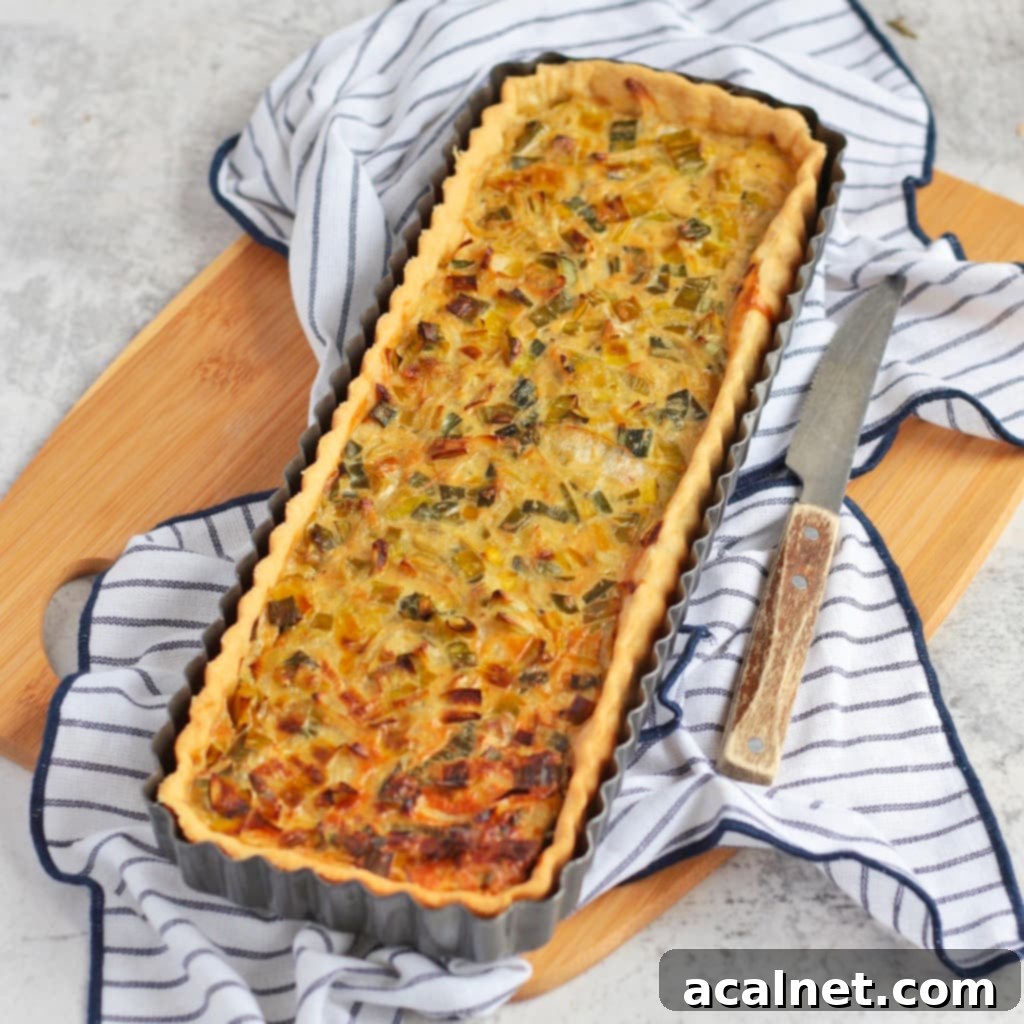 Leek tart in the tart tin on a board