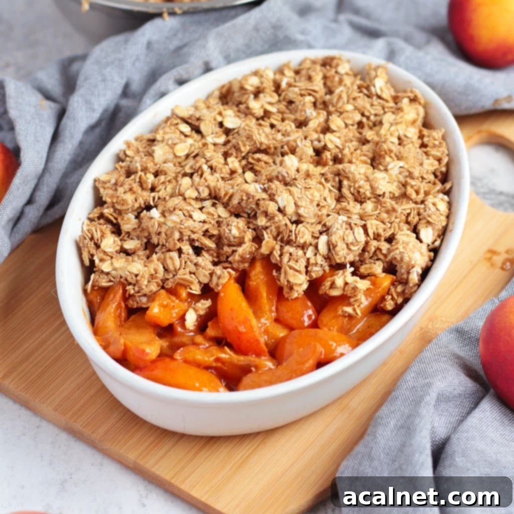 Unbaked fruits half covered by the oat crumble