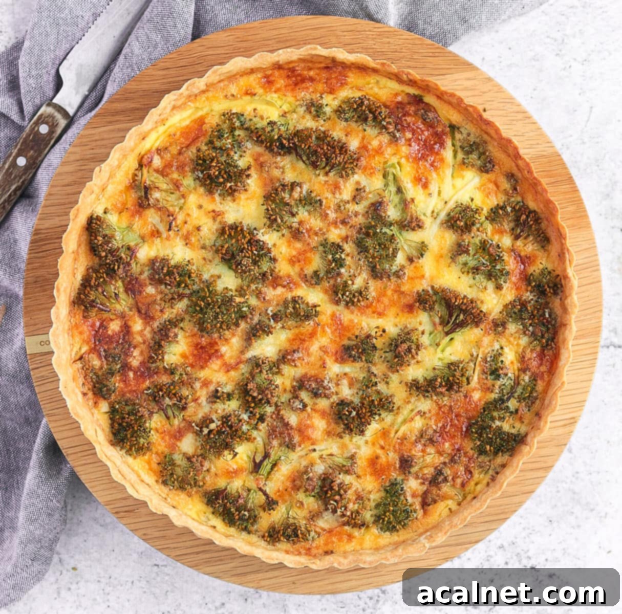 Cheddar Broccoli Quiche, seen from above, with a golden crust and tender broccoli florets amidst a rich filling.