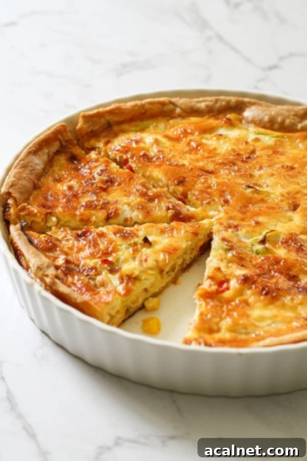 Classic Vegetable Quiche, golden and inviting, with a medley of colorful vegetables visible in the filling.