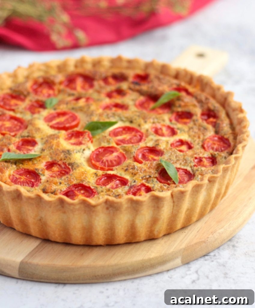 A delicious slice of vibrant tomato quiche on a wooden board, showcasing its rich texture and perfectly baked crust.