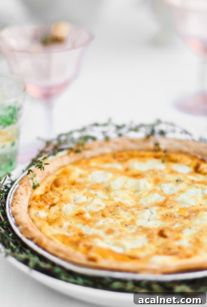 Goat Cheese and Roasted Red Pepper Quiche, beautifully garnished and ready to serve, showcasing vibrant colors.