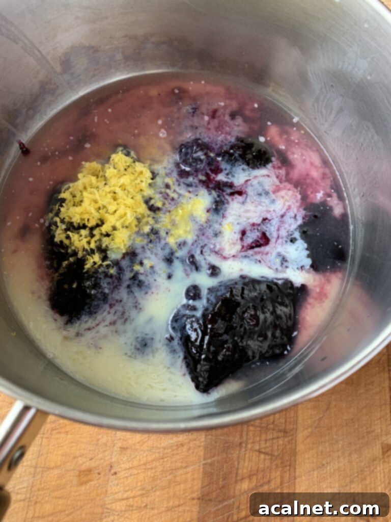 Zesty Lemon Blueberry Coffee Cake 9 Ingredients for the blueberry lemon topping simmering in a saucepan on the stove.