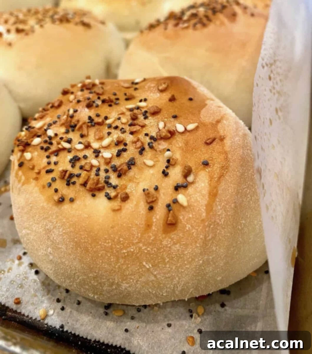 A close-up of a single baked grown-up pig in a blanket, showcasing its golden-brown crust and inviting texture.