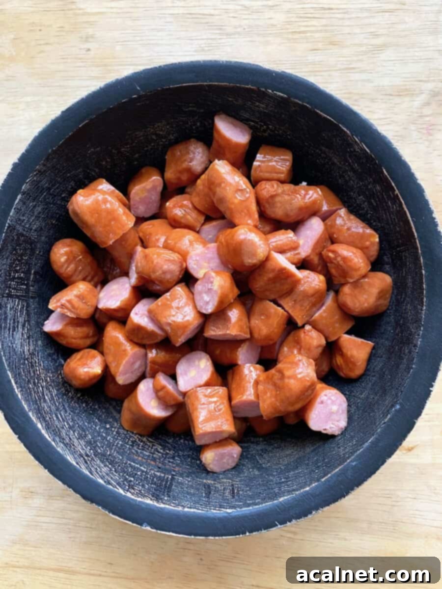 Diced little smokies collected in a bowl, awaiting their turn in the filling.