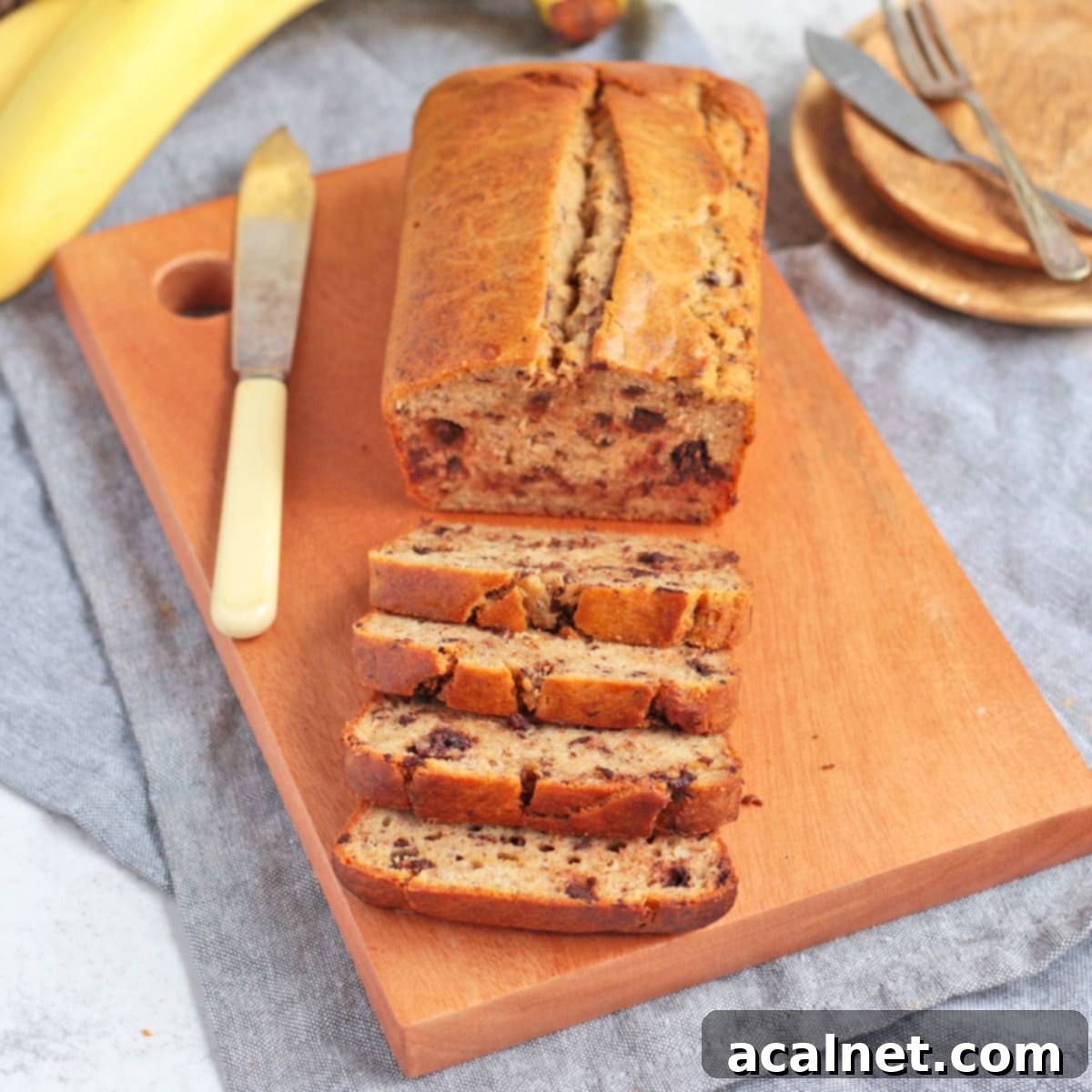 Sliced Quick Bread on a wooden board showcasing a perfectly moist interior with visible chocolate chips.