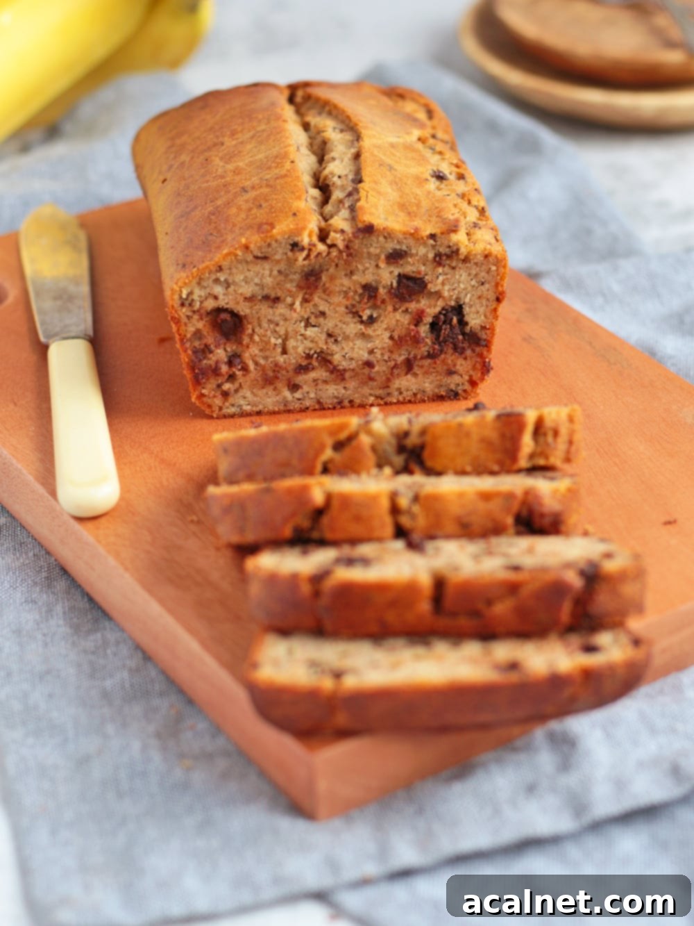 Crumb shot of banana bread with dark chocolate chunks, emphasizing its rich, moist texture.