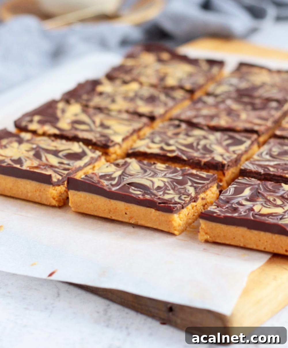Effortless Peanut Butter Crunch Bars 5 Detailed side view of a no-bake peanut butter chocolate bar, showing the distinct layers and the inviting texture.