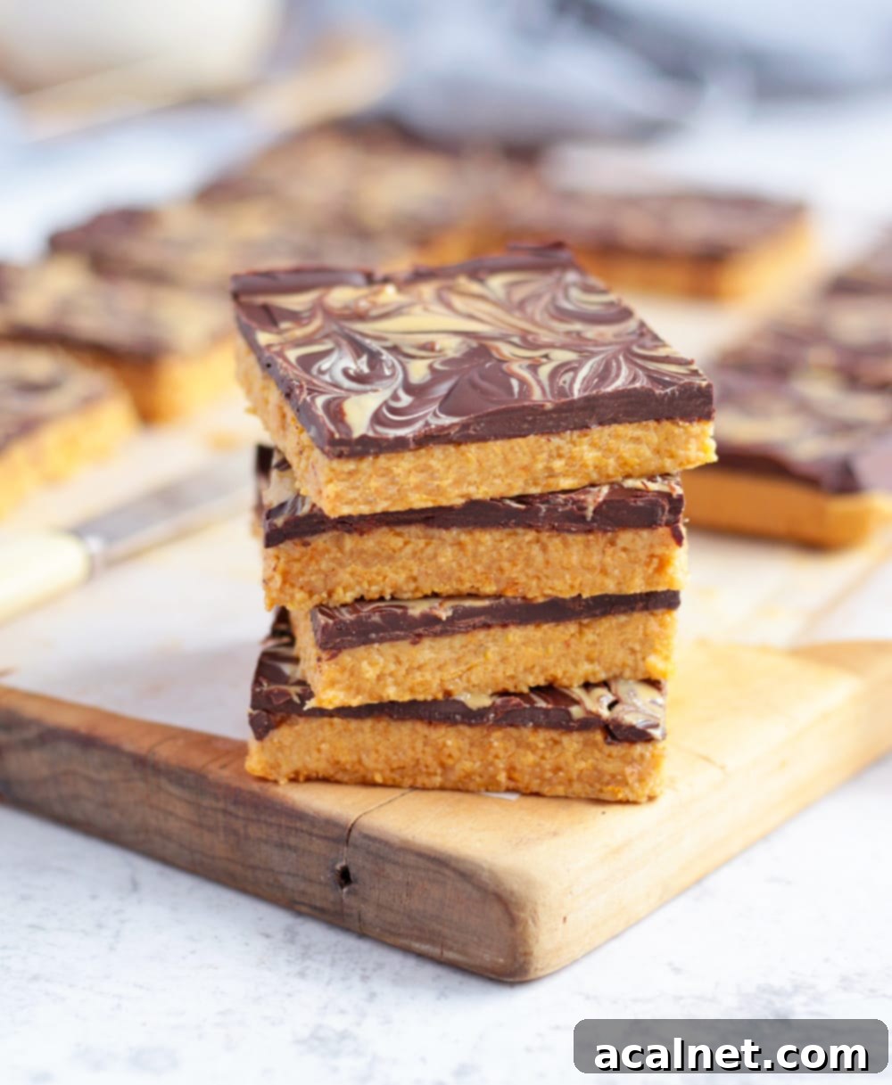 Effortless Peanut Butter Crunch Bars 9 A charming stack of four no-bake peanut butter chocolate bars, ready to be enjoyed.