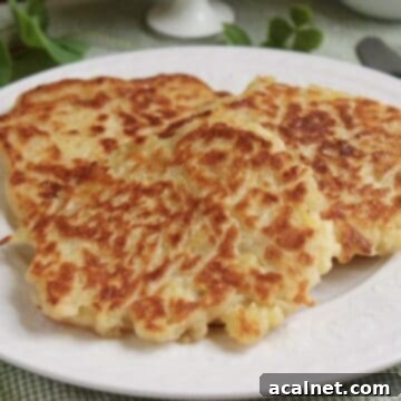 Three Irish pancakes on a plate with a fork on the side