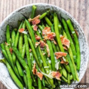 Green beans in a bowl with bacon on top
