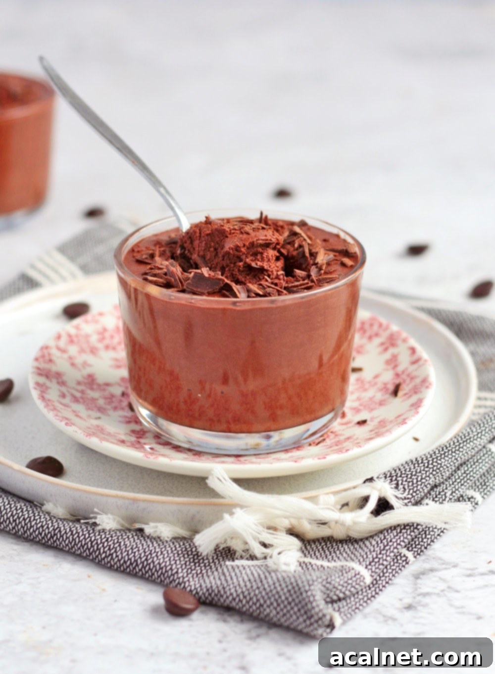 Mousse in a cup with a spoon.
