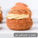 Head on shot of a choux sliced in half and filled with vanilla cream.