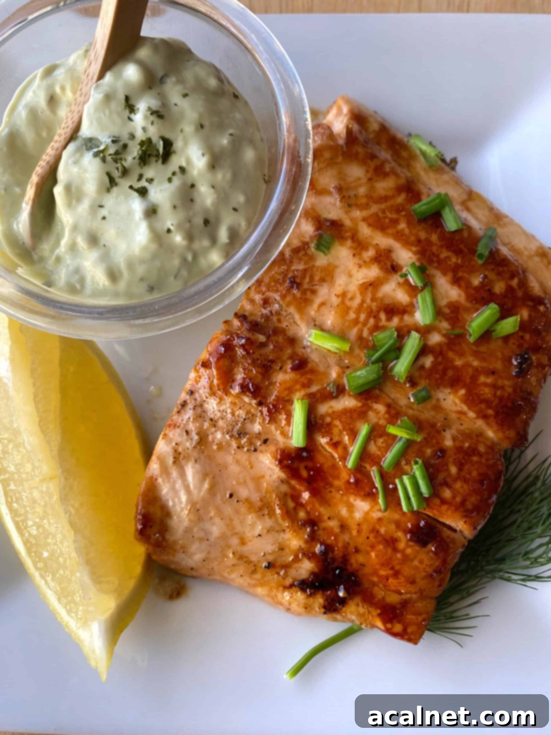Sweet & Sticky Skillet Salmon 3 Salmon on a dish with a wedge of lemon and a small dish of tarter sauce