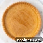 Fully blind baked tart crust seen from above.